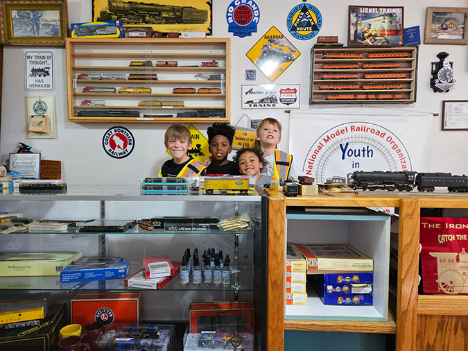 Daecian with his friends and sister Kate at the Youth in Model Railroading store